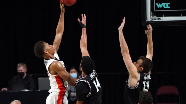Mar 6, 2021; Las Vegas, NV, USA; Pepperdine Waves forward Kessler Edwards (15) shoots the ball over Santa Clara Broncos forward Keshawn Justice (14) and forward Josip Vrankic (13) in the first half at Orleans Arena. Mandatory Credit: Kirby Lee-USA TODAY Sports